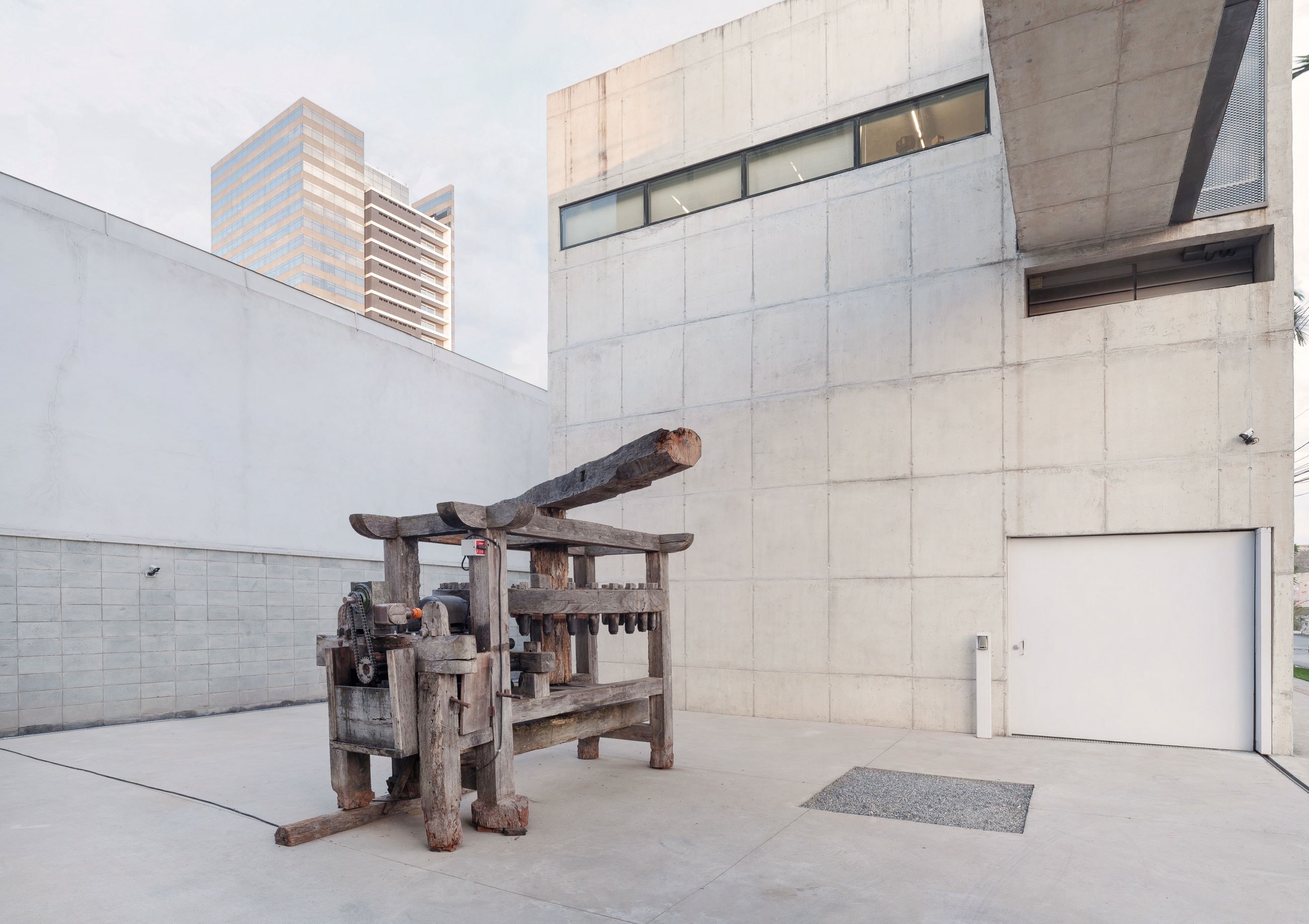 Site-specific Installation titled Phantom Matrix by artist Beto Shwafaty consisting of Sugarcane mill, electric motor, loudspeaker and audio, curated by Bruno Alves de Almeida for the project SITU at Galeria Leme, São Paulo, Brazil.