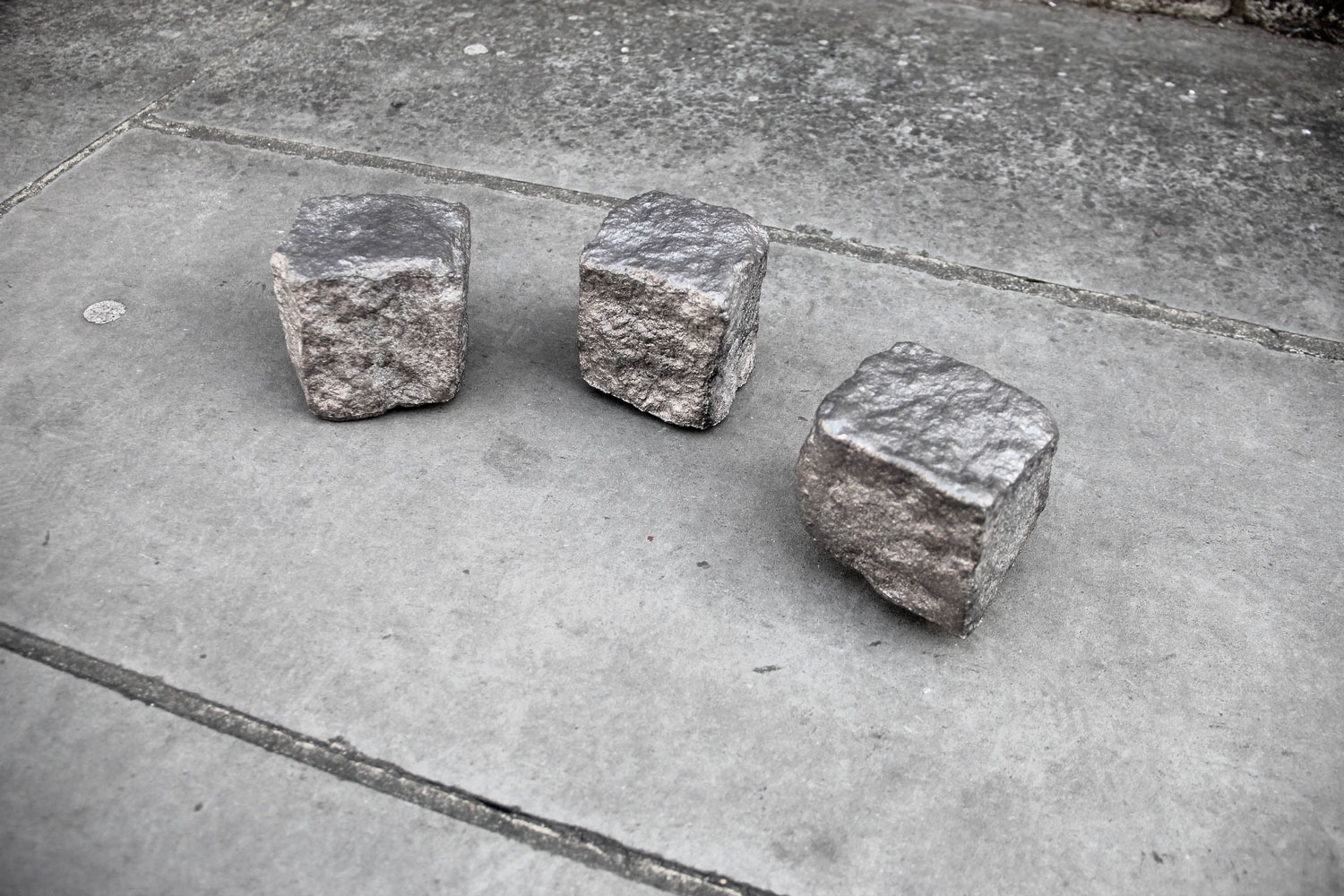 three metallic cobblestones, Daniel de Paula's work assertion/ expulsion